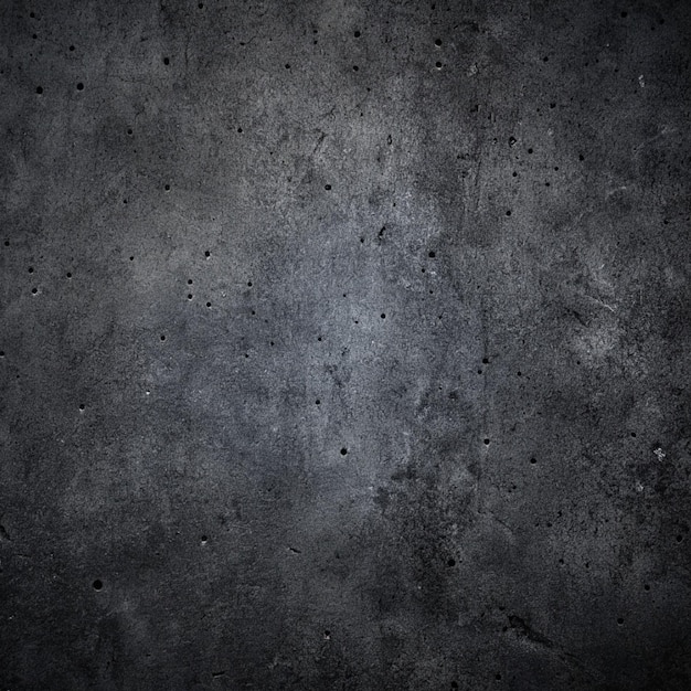 a dark grey wall with a dark grey background with a small patch of blotches