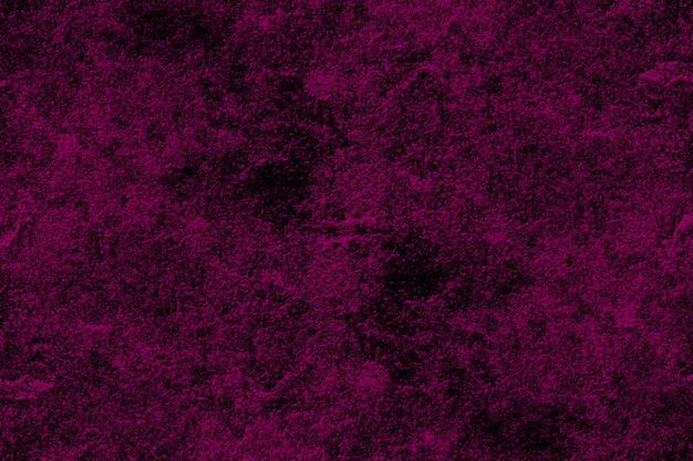 Dark magenta color rough concrete wall surface with scattered heavy grunge texture for background