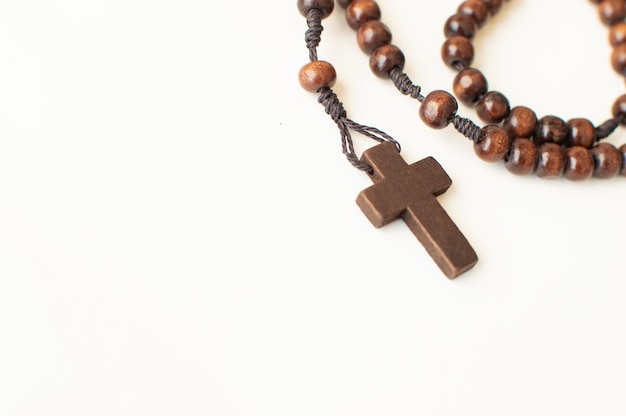 Dark mahogany wooden rosary on a white background holy week customs in latam