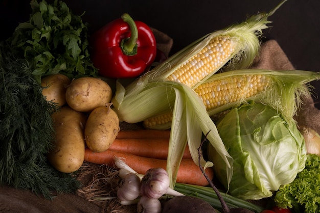 Dark moody still life of fresh vegetables on a wooden table healthy organic local food