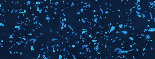 Dark navy blue sparkling background from big foil turquoise sequins macro Texture backdrop with shiny crumb pattern