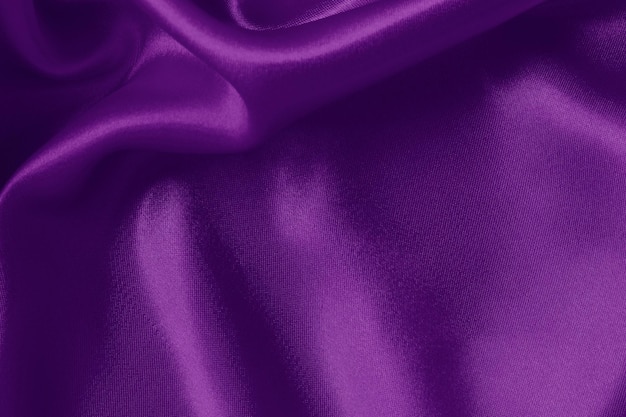 Dark purple fabric texture background crumpled pattern of silk or linen