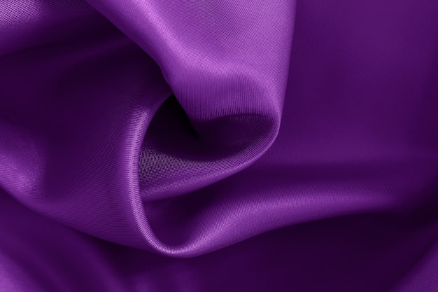 Dark purple fabric texture background, crumpled pattern of silk or linen.