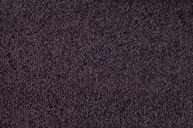 Dark purple fluffy background of soft, fleecy cloth