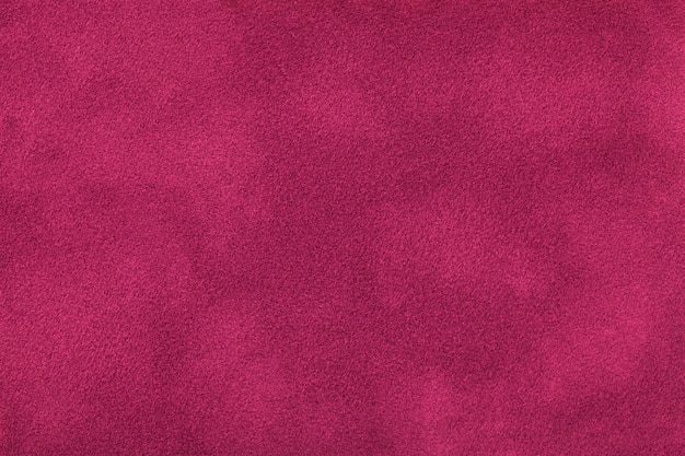 Dark purple matt suede fabric closeup. Velvet texture.