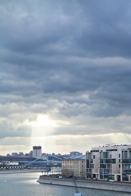 Dark rainy clouds and sunbeams over Moscow city