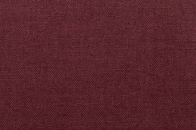 Dark red background from textile material. 