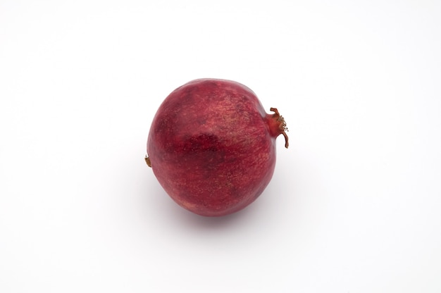 Dark red pomegranate fruit on white background