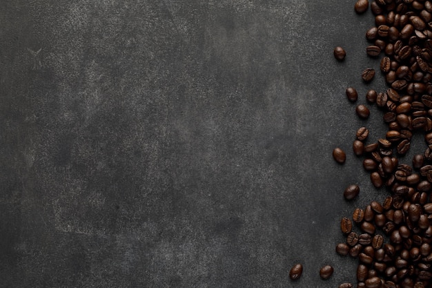 Dark roasted coffee beans on concrete background abstract banner