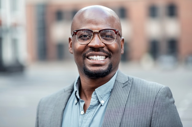 Dark-skinned businessman. Dark-skinned handsome businessman wearing stylish striped jacket smiling broadly