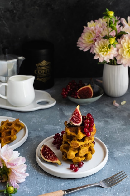 Dark still life, breakfast waffles and fresh figues