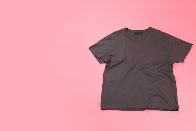 Dark t-shirt with space for print on pink background