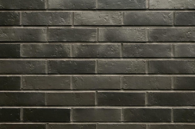 A dark wall of bricks Background texture of the wall of the building