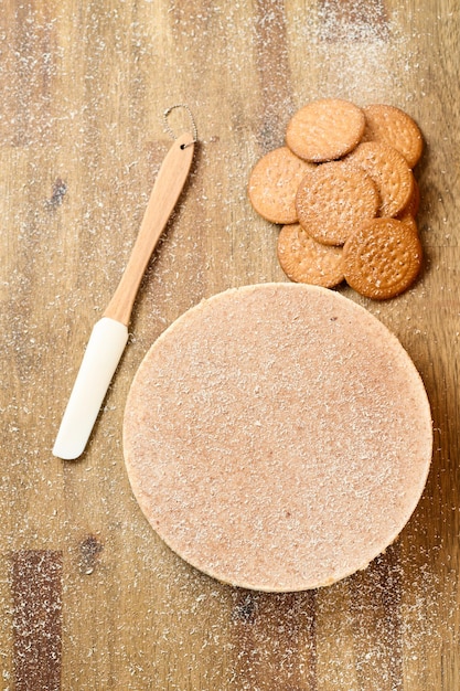 Dark and white chocolate cake with cookies on wood background