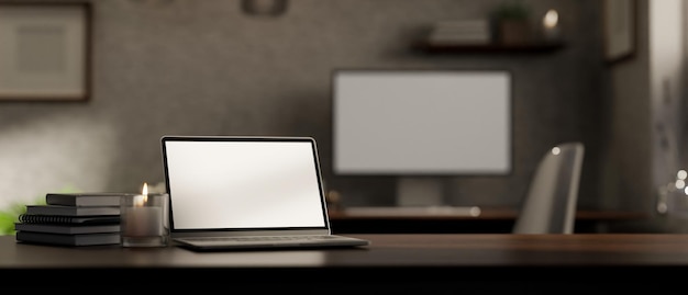 Dark wood tabletop workspace with laptop mockup and copy space against blurred office background