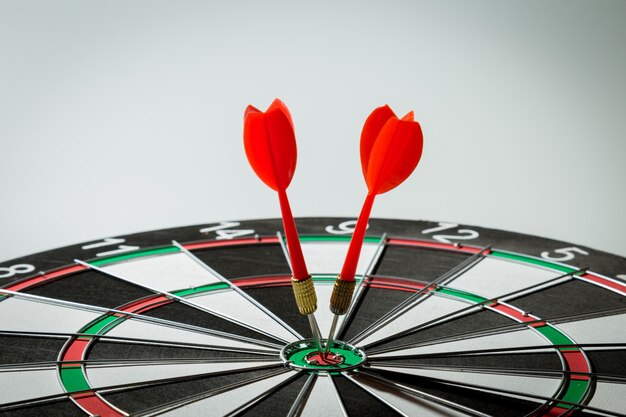 Dart arrow hitting in the target center of dartboard. concept of the success