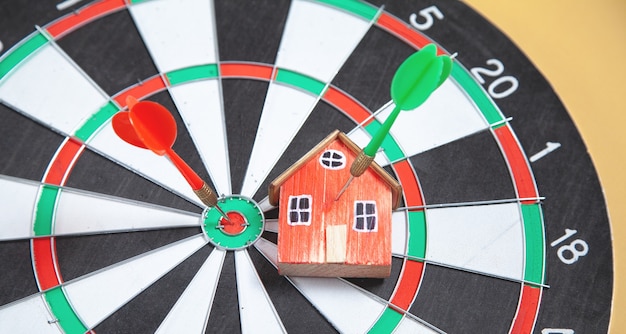 Dart arrow, house model on dartboard.