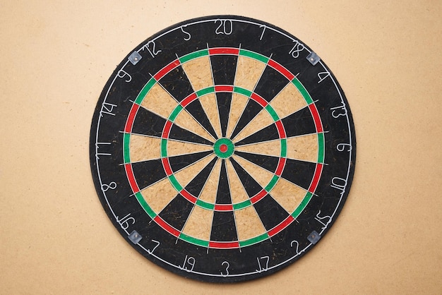 Dart board front view on a brown isolated background. Target.