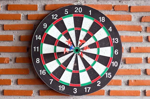 dart game on brick wall