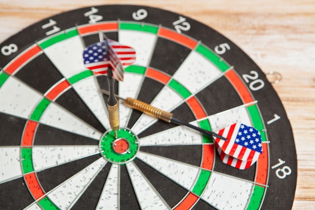 darts in the center of the target on wooden