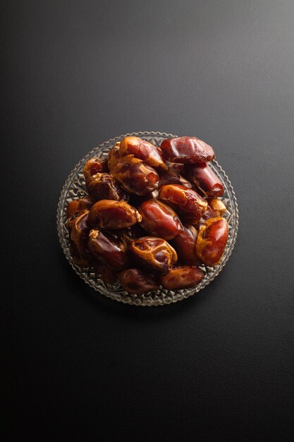 Dates fruit on dark background with copy spaces. Arabian fruit. Ramadhan season.