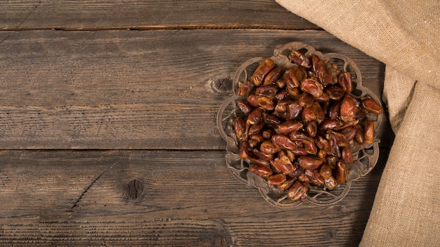 Dates fruit on plate on wooden table