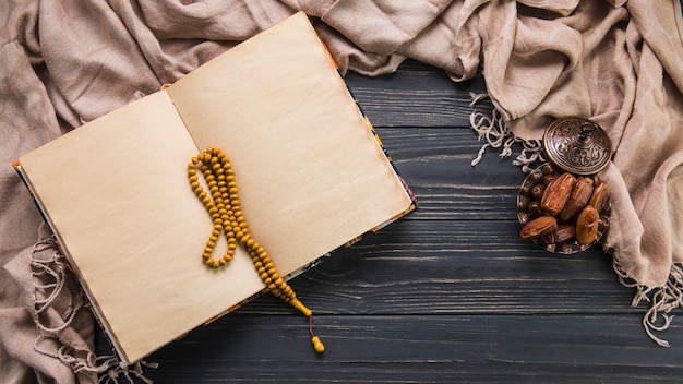 Dates fruit with blank notebook and beads