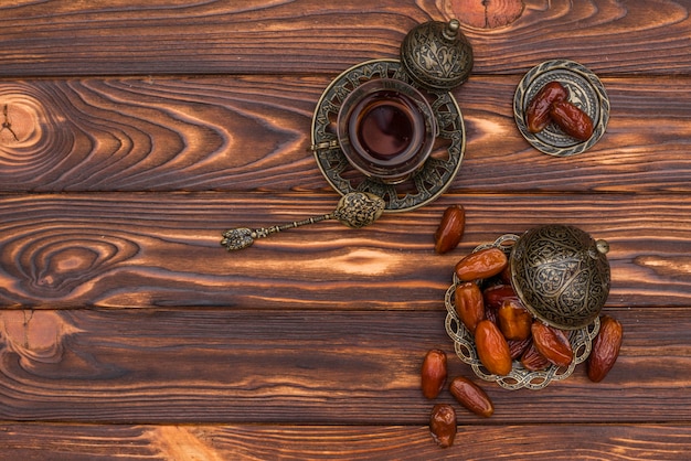 Dates fruit with tea cup on table