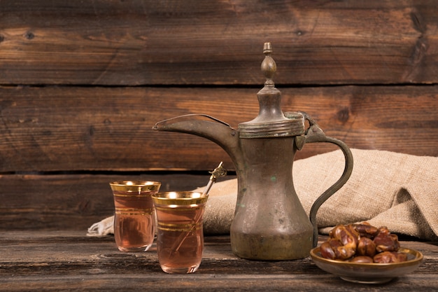 Dates fruit with tea glasses on table