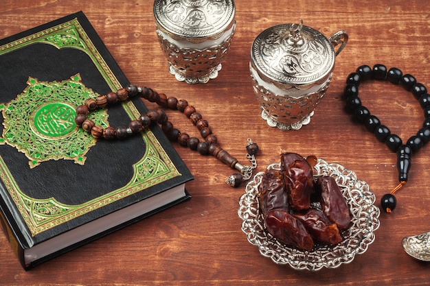 Dates, Koran and wooden rosary beads