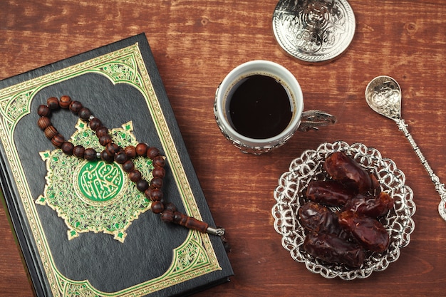 Dates, Koran and wooden rosary beads