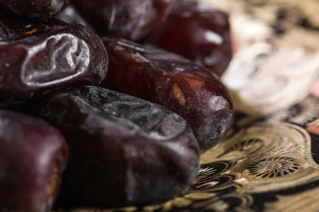 Dates in plate on wooden table