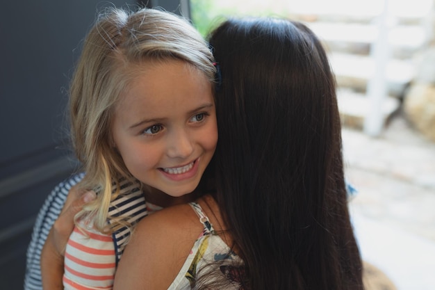 Daughter embracing her mother in a comfortable home