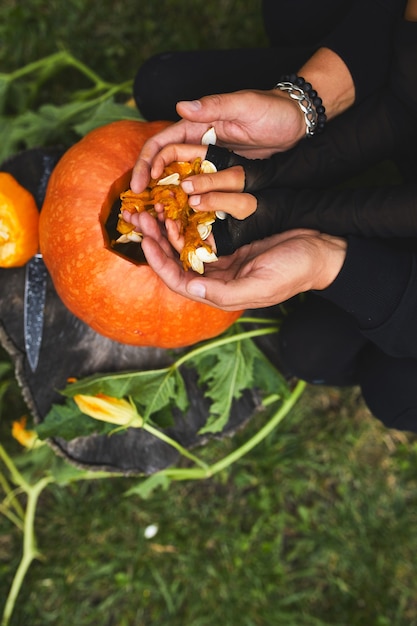 Daughter and father hands carving pumpkin for Halloween, Prepares Jack o'Lantern