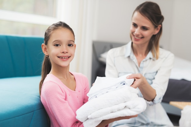 The daughter helps the mother with household chores.