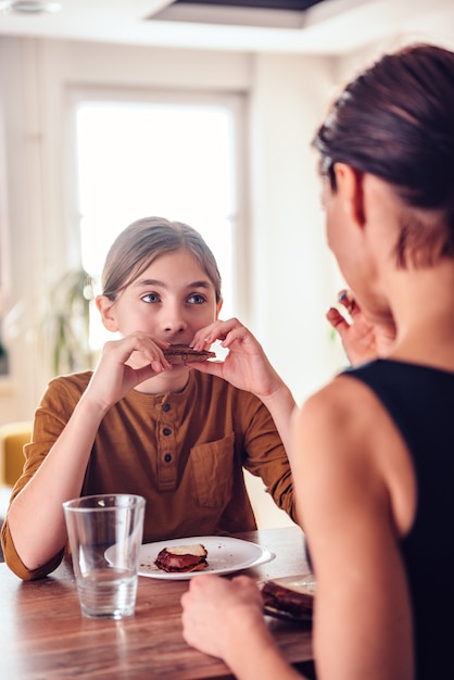 Daughter and mother having breakfast