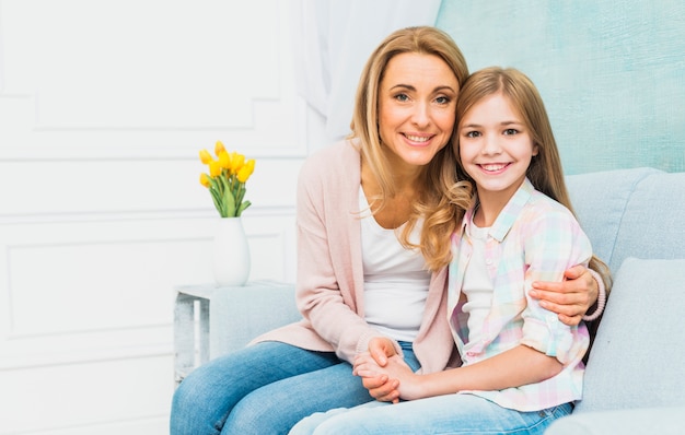 Daughter and mother smiling and hugging