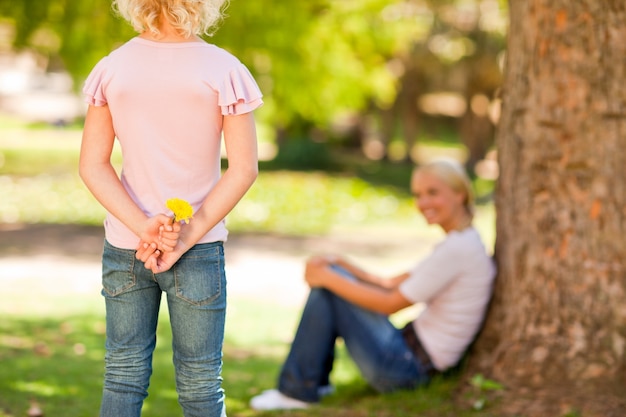 Daughter offering a flower to her mother