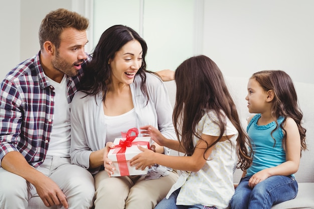 Daughters giving a gift to her parents 