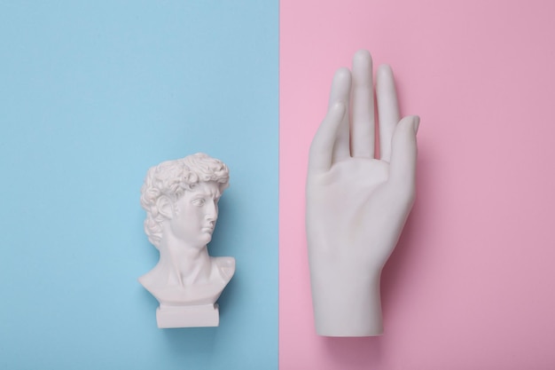 David bust with on hand on pink blue background Creative layout Concept pop Minimal still life Flat lay Top view