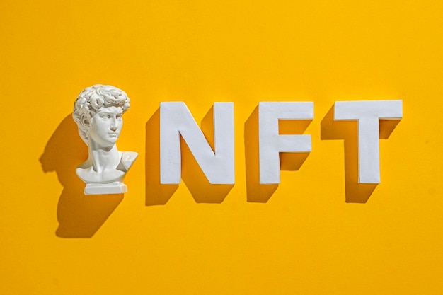 David statue bust and NFT 3D text on a bright background as a concept of crypto art and finance and technology of the future