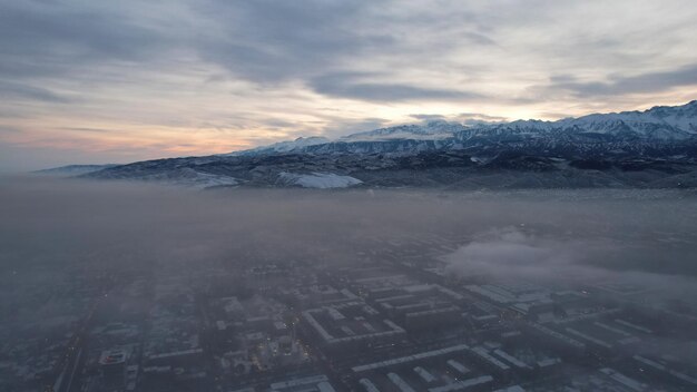 Dawn over the city in fog and smog mountain view