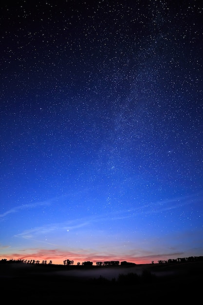 Dawn on a starry background sky and the Milky Way.