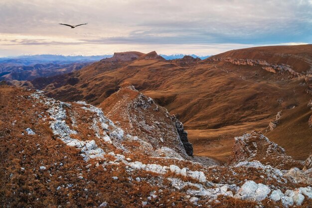 Dawn view of Bermamyt plateau rocks Mountains on the edge of a cliff in the distance on dramatic morning Atmospheric landscape with silhouettes of mountains KarachayCherkessia Caucasus Russia