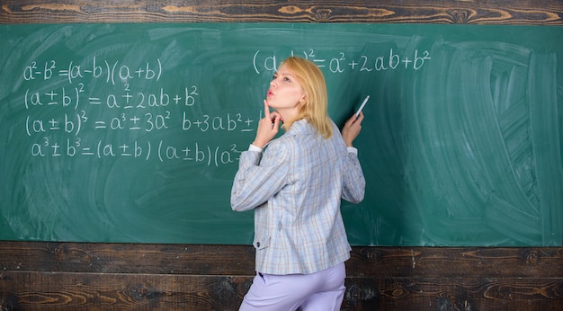 Day dreaming at school Home schooling thoughtful woman Study and education Modern school Knowledge day teacher on school lesson at blackboard Back to school Teachers day woman in classroom