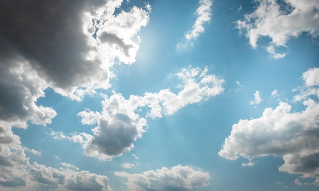 DAY SKY WITH BLUE AND WHITE CLOUDS and sun beam behind