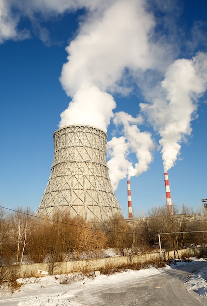 Day view of power plant, smoke from the chimney