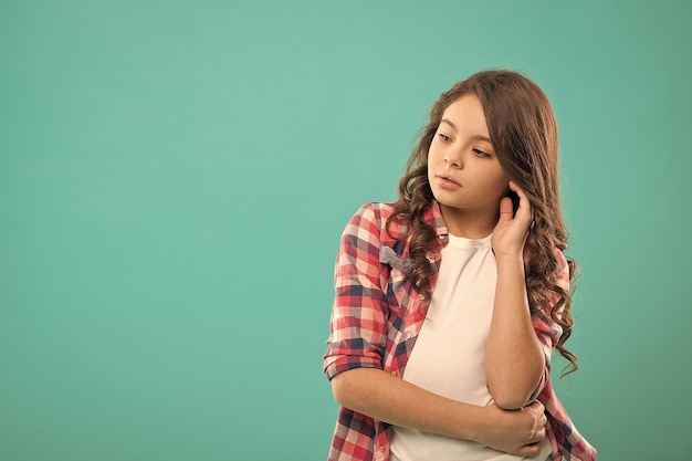 Daydreaming concept Kid thoughtful face make decision Child cute curly hair thinking Girl casual look make hard decision or choice Hard decision for her Thoughtful girl busy with hard decision