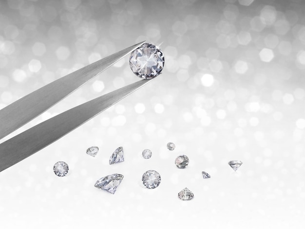 Dazzling diamond held in tweezers on a bokeh background