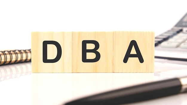 DBA a word written on wooden cubes on a white background